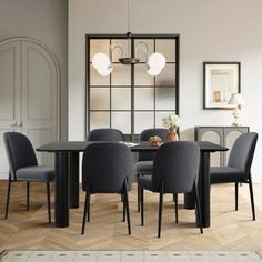 a dining room table with four chairs around it