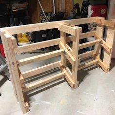 a wooden bench made out of pallets in a garage