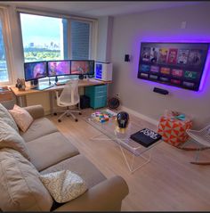 a living room filled with furniture and a flat screen tv mounted to the side of a wall