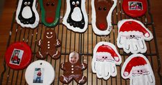 decorated cookies on a cooling rack with pictures and santa hats