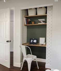 a white chair sitting in front of a desk with a clock on top of it