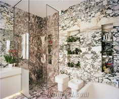 a bathroom with marble walls and flooring