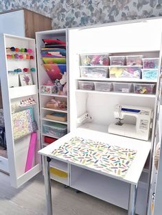 a sewing machine sitting on top of a table next to a shelf filled with craft supplies