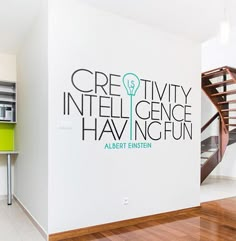 a white wall with an advertisement on it that says creativity in the language of having fun