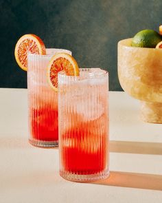 two glasses filled with blood oranges and lemonade