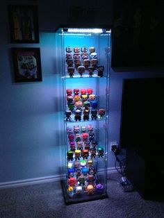 a lighted display case filled with lots of toys