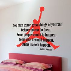 a bedroom with a bed and a basketball wall decal