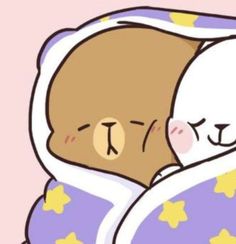 a teddy bear wrapped in a blanket with stars on it's chest and eyes closed