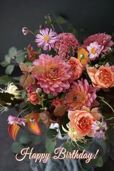 a vase filled with lots of flowers on top of a table