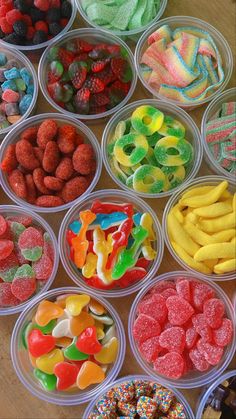 several plastic containers filled with different types of candies