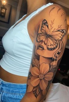 a woman with a butterfly on her shoulder and flowers in front of her arm,