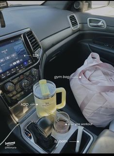 the inside of a car with various items in it and an info sheet on the dashboard