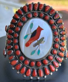 This is a show stopper indeed. This beautiful handmade Zuni Cardinal Inlay includes Mother of Pearl, Coral, Turquoise, Abalone and Jet set in Sterling Silver. Size 6 1/2 Gap 1" 75.3 g/ 2.66 oz Face Size 2 3/4" x 2 1/2" No flex in this cuff. This means no squeezing to make fit or the stones could become compromised. Artisan Red Inlay Jewelry, Artisan Red Jewelry With Inlay, Red Oval Jewelry For Ceremonial Occasion, Artisan Red Oval Jewelry, Handmade Southwestern Red Jewelry, Red Southwestern Style Collectible Jewelry, Handmade Southwestern Red Cuff Bracelet, Handmade Red Southwestern Cuff Bracelet, Traditional Red Multi-stone Jewelry