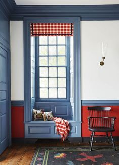 a chair and window in a room with blue trim