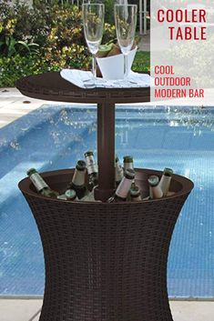 an outdoor table with wine glasses and bottles on it next to a swimming pool that says cooler table cool outdoor modern bar