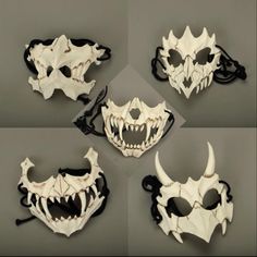 four different masks with teeth and fangs on them