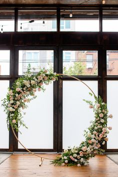 a circular floral arrangement in front of a window