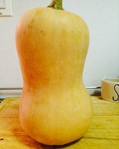 a large yellow apple sitting on top of a wooden table