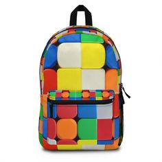 "Rubiks Cube Backpack Have you got room for all that? With our roomy and durable backpack, you will! This bag is made from spun polyester and weights 1.3 lbs, just enough to be light, strong and long-lasting. Grab it, stow it, throw it onto the seat next to you, this backpack can take it, and so will you, wherever you go! .: 100% polyester .: Lightweight and waterproof .: Adjustable shoulder straps .: Custom name tag sewn inside .: NB! Size variance +/- 0.5\" .: NB! Dashed lines used in the cut & sew process may be visible in the front pocket's interior .: Assembled in the USA from globally sourced parts" Rectangular Nylon Backpack For School, Multicolor Nylon Student Bag, Multicolor Rectangular School Backpack, Multicolor Standard Backpack, Multicolor Standard Backpack For Back To School, Multicolor Standard Backpack For Study, Multicolor Softback Backpack For Students, Multicolor Rectangular Nylon Backpack, Custom Rubiks Cube