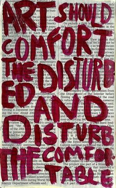 the words art should comfort the disturb and destroy the table written on an old book page