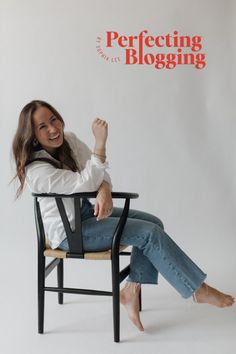 a woman sitting in a chair with her legs crossed and arms up, smiling at the camera