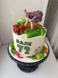 there is a cake that has been decorated with vegetables