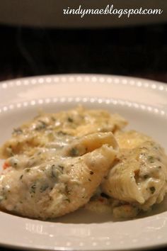 a white plate topped with ravioli and cheese