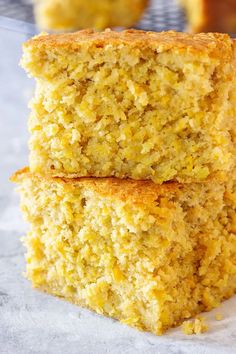 two pieces of cornbread sitting on top of each other next to a muffin