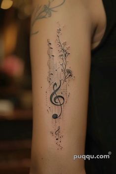 a woman's arm with music notes and trebles on the left side