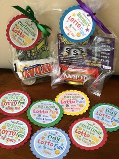 some candy and candies are sitting on a table with the name tags attached to them