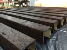 several pieces of wood sitting on top of a tarp in a room with shelves