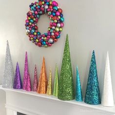 colorful christmas decorations are displayed on a mantel