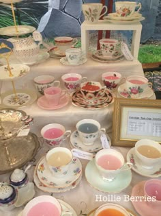 a table topped with lots of cups and saucers