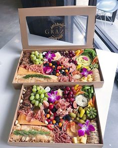 two wooden boxes filled with different types of food