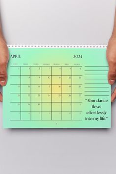 two hands holding a calendar with the month on it, and another person's hand