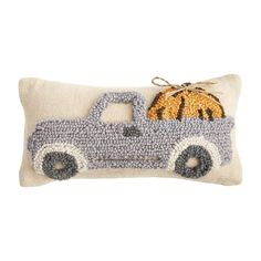 a pillow with a truck and pumpkin on it