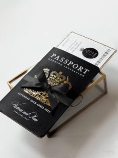 a passport sitting on top of a metal stand with a black ribbon around it's bow