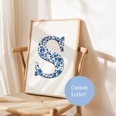 a wooden chair with a framed letter s on it