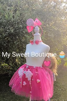 a mannequin wearing a pink tutu skirt with hearts and flowers on it