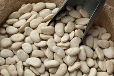 a bag filled with white beans sitting on top of a table