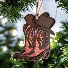 a cowboy boot ornament hanging from a christmas tree