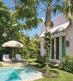 an outdoor swimming pool surrounded by palm trees