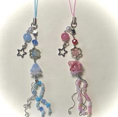 two necklaces with beads and charms hanging from them