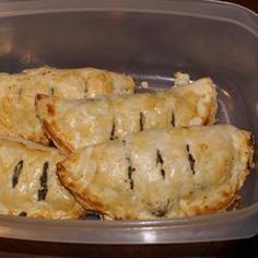 several pastries in a plastic container on a table