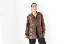 * Classic wardrobe staple 80s blouse * Leopard print  * Poly * Longline and roomy with a great drape  * Works as a shirt dress or tucked into any bottoms * Perfect with a red lip SIZING: Generous Medium will suit a range // * UK & AU Womens 10 - 14 // * US Womens 6 - 10 MEASUREMENTS [Taken laid flat]:  Underarm - underarm: 58cm // Length: 75cm Vintage Oversized Shirt For Fall, Oversized Vintage Shirt For Fall, Oversized Graphic Print Blouse For Fall, Oversized Fall Blouse With Graphic Print, Retro Relaxed Fit Blouse For Fall, Retro Oversized Blouse For Spring, Oversized Vintage Button-up Blouse, Oversized Collared Vintage Blouse, Vintage Oversized Blouse For Spring