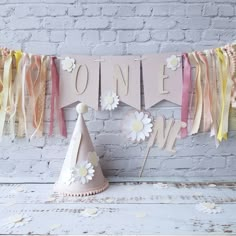 a party hat sitting on top of a table next to a sign that says one love