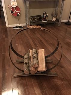 a wooden log sitting on top of a metal circular object in a living room next to a christmas tree