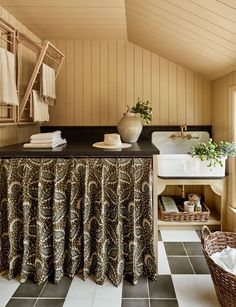 a bathroom with black and white tile flooring next to a tub, sink and window