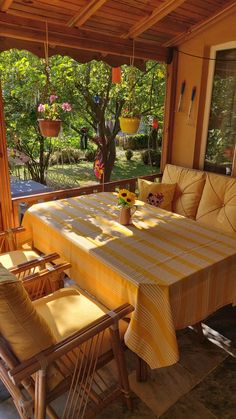 a table and chairs on a covered porch