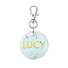 a keychain with the word lucky printed on it's front and back